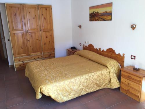 a bedroom with a bed and a wooden cabinet at Hotel Campo Felice in Lucoli Alto