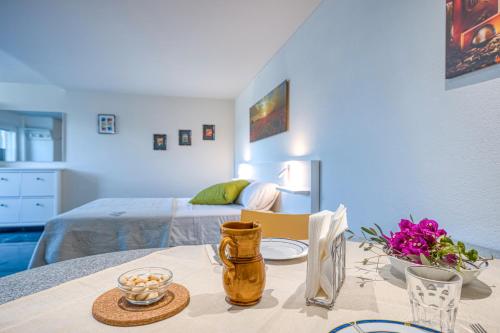 a room with a table with a bed in the background at Residence Margherita in Ugento
