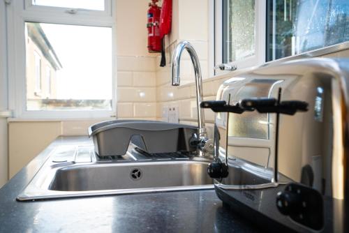 a kitchen sink with a faucet on a counter at Haven House in Bath