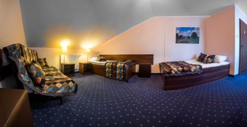 a hotel room with two beds and a sink at Hotel Colnus in Kolno