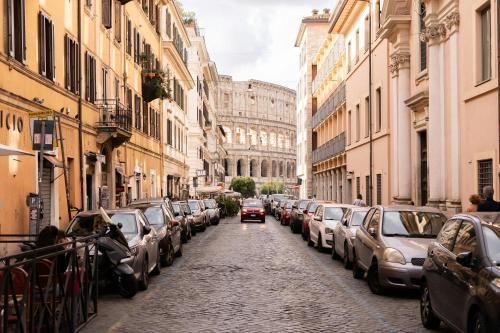a car driving down a street with parked cars at MagicHouse 2 Camere 2 Bagni -15 min Colosseo in Rome