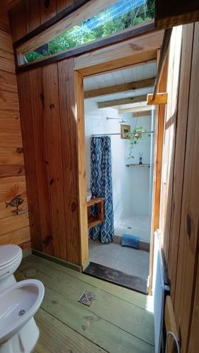 a bathroom with a toilet and a shower in a house at Del Bosque Surf Ranch in Villa Gesell