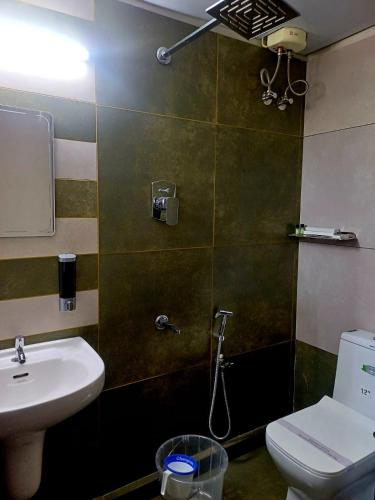 a bathroom with a sink and a toilet at Vajra Periyar Heritage in Alwaye