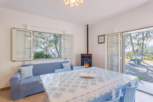 a living room with a blue couch and a table at Casa Mulas in Tertenìa