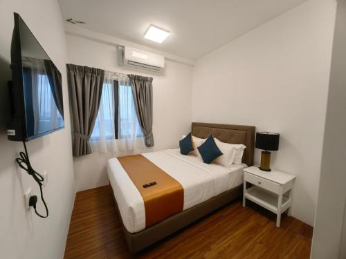 a bedroom with a bed and a flat screen tv at UCSI Residence 2 By UCSI Hotels in Kuala Lumpur