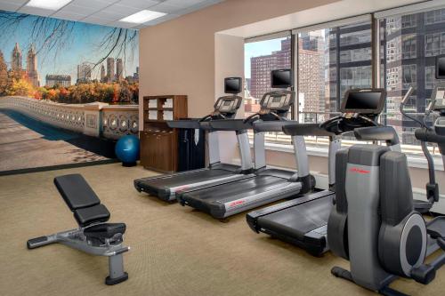 a gym with cardio equipment and a large window at Courtyard New York Manhattan/Midtown East in New York