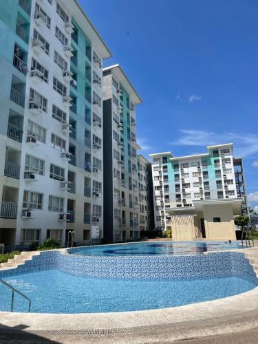 a swimming pool in front of some apartment buildings at Gin Studio Rent Davao in Davao City