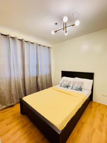 a bedroom with a large bed in a room at Gin Studio Rent Davao in Davao City