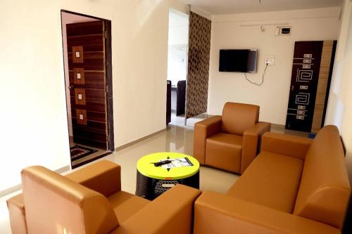 a living room with a couch and chairs and a table at Horizon Grande Apartments - Tarkarli in Malvan