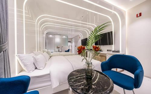 a bedroom with a white bed and blue chairs at Forestar Hotel in Seoul