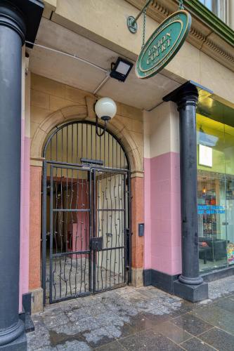 an entrance to a store with a gate on a building at Stunning Central Station 2 Bed Apartment B4 in Glasgow