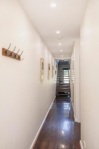 a hallway of a home with white walls and wooden floors at Halls Gap Escape Townhouses in Halls Gap