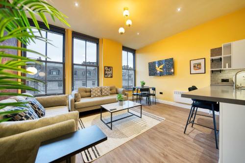 a living room with a couch and a table at Lovely Central Station 1 Bed Apartment A6 in Glasgow