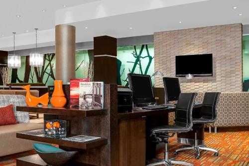 a hotel lobby with a desk with two computers at Courtyard New York Manhattan/Upper East Side in New York