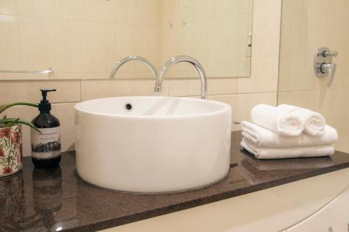 a white sink sitting on a counter in a bathroom at Halls Gap Escape Townhouses in Halls Gap