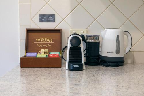 a kitchen counter with a coffee maker and a blender at Halls Gap Escape Townhouses in Halls Gap