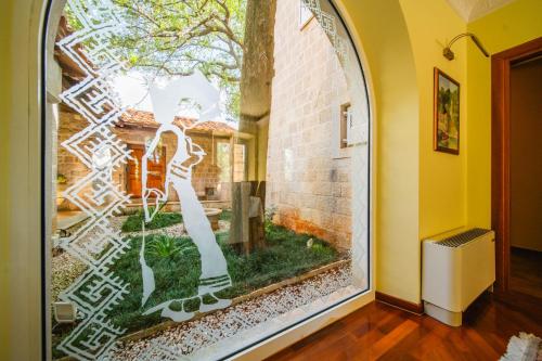 a window of a home with a garden in it at Villa Tereza in Čilipi