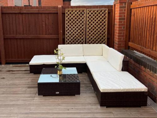 two white couches and a table on a patio at Private Bedroom in Unique Luxury House, Salford, Manchester in Manchester