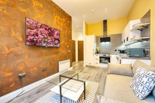 a living room with a couch and a kitchen at Lovely Central Station 1 Bed Apartment B10 in Glasgow