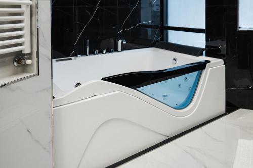 a white bathroom with a black and white tub at Grand Hotel Europa in Isernia