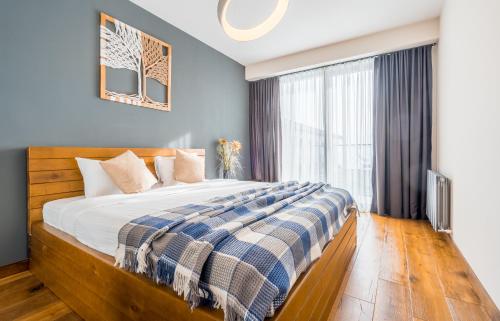 a bedroom with a large bed and a window at New Gudauri Apartments in Atrium in Gudauri
