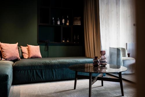 a living room with a green couch and a table at Badia Hill in Badia