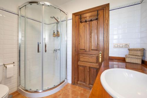 a bathroom with a shower and a sink and a toilet at Casa Rural Casa Selmo in Carreno