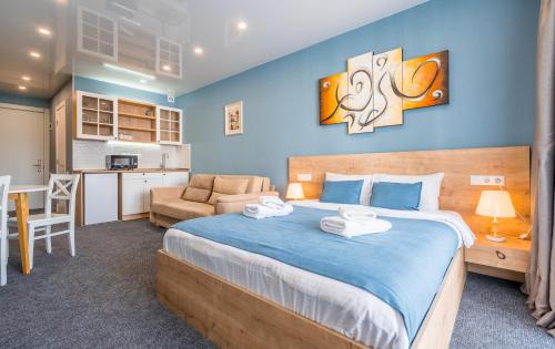 a bedroom with a large bed and a kitchen at New Gudauri Apartments in Atrium in Gudauri