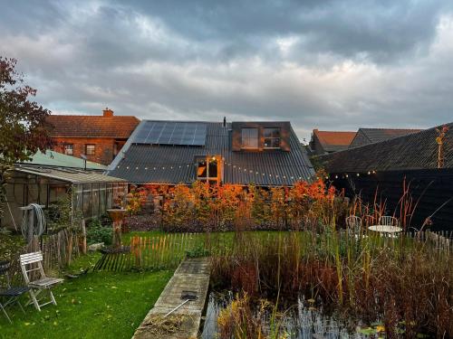 a house with solar panels on top of it at B&B Maas en Heuvel Maastricht in Maastricht