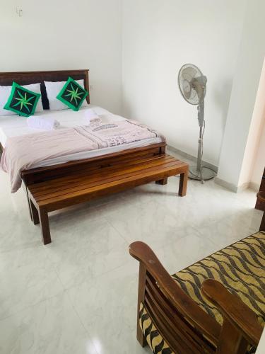 a bedroom with a bed and a fan at Broad view in Ella