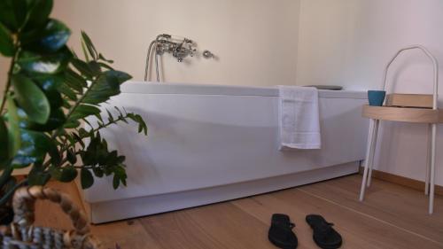 a bathroom with a bathtub with a towel and a stool at Nine Rooms Double in Trento