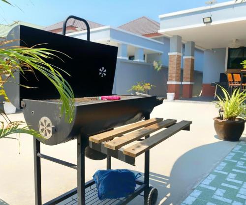 a barbecue grill and a picnic table on a patio at Hotel Royale in Jomtien Beach