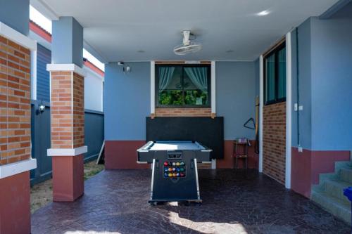 a ping pong table in a room with blue walls at Hotel Royale in Jomtien Beach