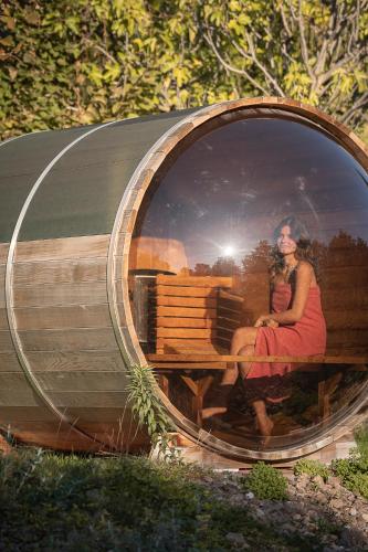 a woman and a woman sitting in a round window at Schloss Hotel Korb in Appiano sulla Strada del Vino