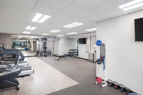 a gym with treadmills and machines in a room at Courtyard by Marriott Baton Rouge Downtown in Baton Rouge