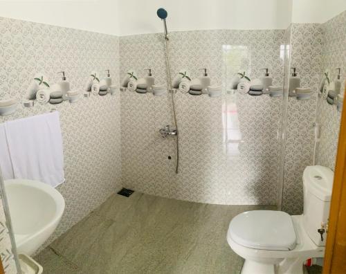 a bathroom with a shower and a toilet and a sink at Broad view in Ella
