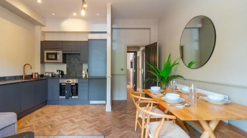 a kitchen and dining room with a table and a mirror at Hy Lytham St Anne's in Lytham St Annes