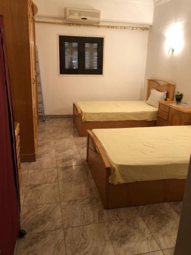 a hotel room with two beds and a window at Apartment sea view in Hurghada