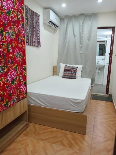 a bedroom with a white bed in a room at Luna travel in Hanoi