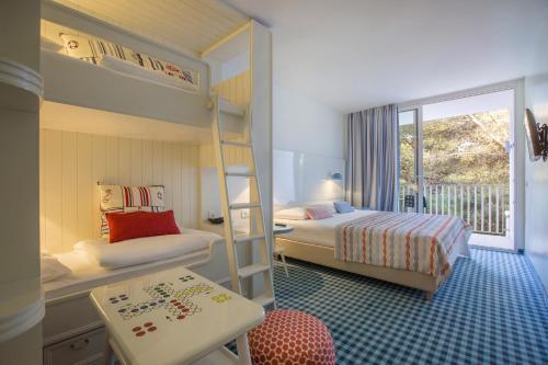 A bed or beds in a room at Amadria Park Kids Hotel Andrija