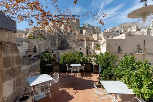a patio with tables and chairs in front of buildings at Gradelle San Nicola in Matera