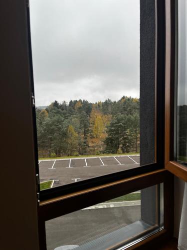 a view of a parking lot through a window at Šumska staza Divčibare apartmani in Divčibare
