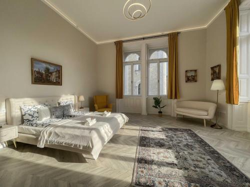 a bedroom with a large bed and a chair at Luxury Apartment Opposite Budapest Opera, Central, AC, Metro 1, Sleeps 6 in Budapest