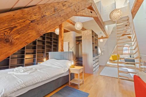 a bedroom with a bed and a staircase at Loft avec vue sur la Cathédrale de Fribourg in Fribourg