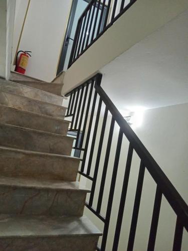 a staircase in a house with a stair railing at Luna travel in Hanoi