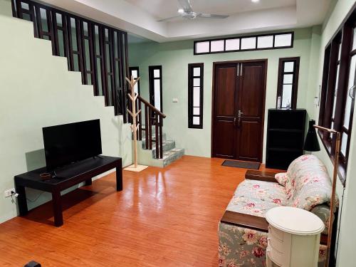 a living room with a couch and a tv at 103-25 Kathu Waterfall in Phuket Town