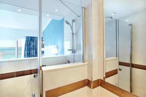 a bathroom with a shower with a glass door at Universal Hotel Marqués in Colònia de Sant Jordi