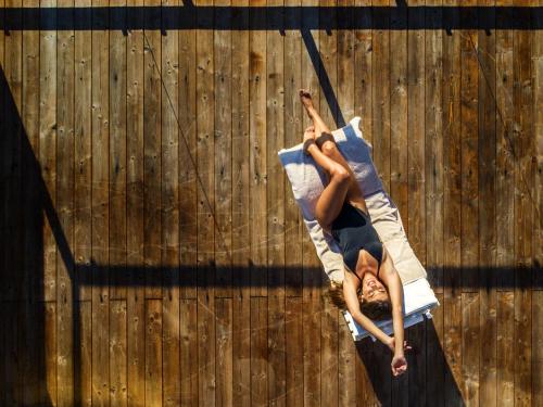 a man is on a climbing rope in front of a wooden fence at Hotel Santa Caterina in Palinuro