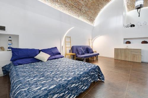 a bedroom with a bed and a chair in it at Casa al mare in Pietra Ligure