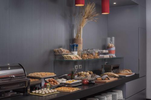 a buffet line with various pastries and other foods at NH Trieste in Trieste
